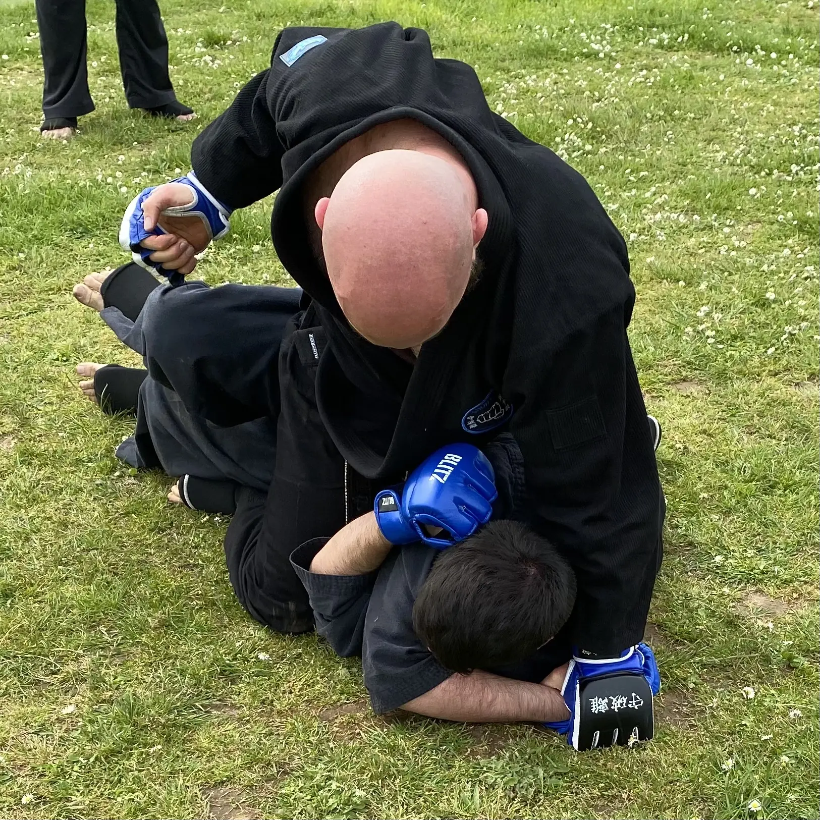 Olgun Tiltay of  Shuhari Self Defence practicing ground and pound during  sparring in an MMA class in Maidenhead